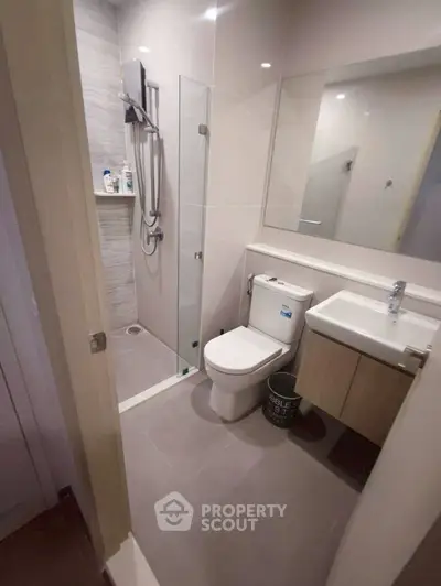 Modern bathroom with sleek shower and compact design