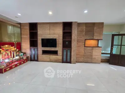 Spacious living room with modern built-in entertainment center and elegant decor.