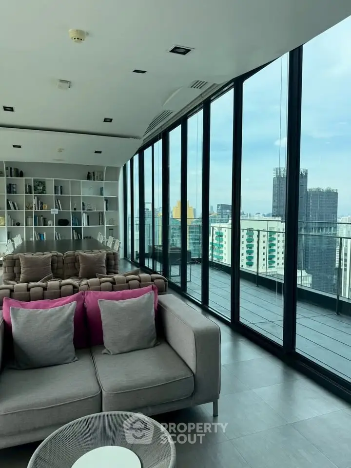 Luxurious modern living room with panoramic city views and stylish decor.