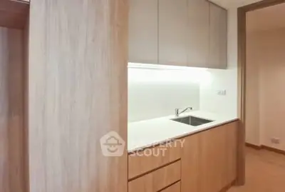 Modern minimalist kitchen with sleek cabinetry and integrated sink