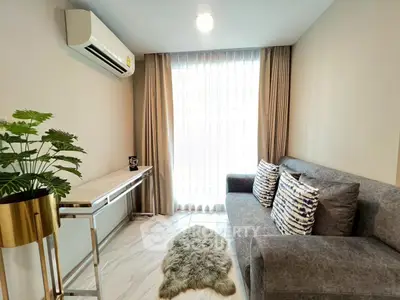 Modern living room with sleek furniture and natural light, featuring a cozy sofa and stylish decor.