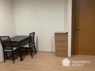 Cozy corner dining area with wooden table and chairs near entrance door