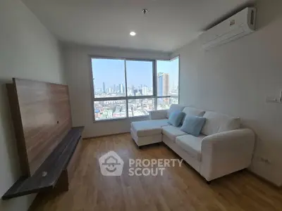 Modern living room with city view, featuring a cozy white sofa and sleek wooden flooring.