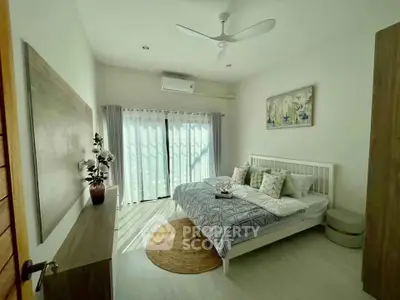 Bright and airy bedroom with modern decor and large window