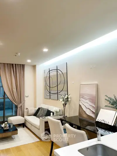 Modern living room with elegant decor and open layout, featuring stylish furniture and contemporary artwork.