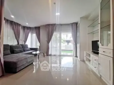 Spacious living room with modern decor and large windows for natural light.