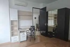 Spacious study room with modern furniture and ample storage space.