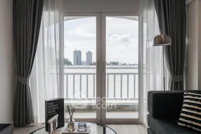 Stylish living room with balcony view in modern apartment