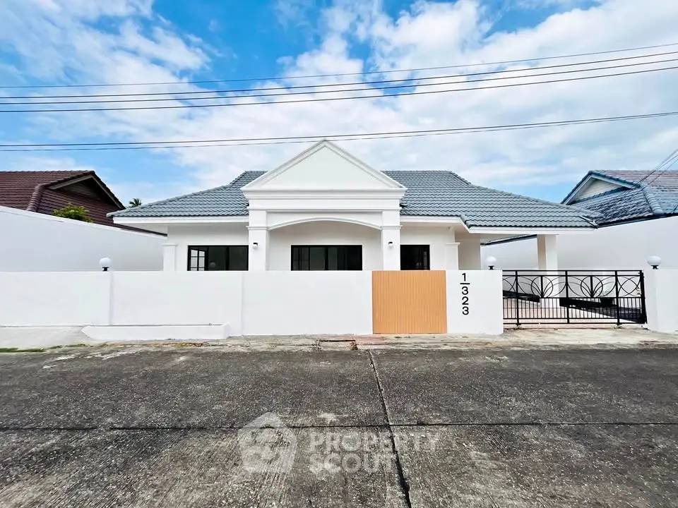 Charming single-story house with modern design and spacious driveway in a serene neighborhood.