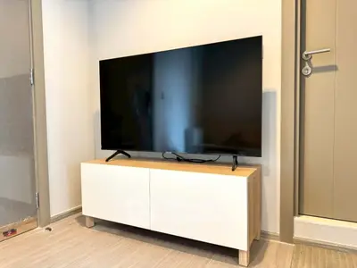 Modern living room with sleek TV stand and flat-screen TV
