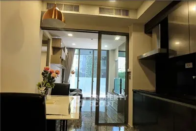 Modern open-plan living room with sleek kitchen and balcony view