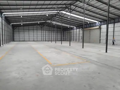Spacious industrial warehouse with high ceilings and ample storage space.