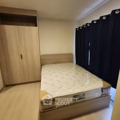 Cozy bedroom with wooden wardrobe and comfortable bed, perfect for restful nights.