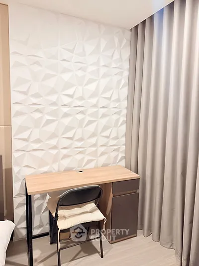 Modern study corner with geometric wall design and elegant curtains