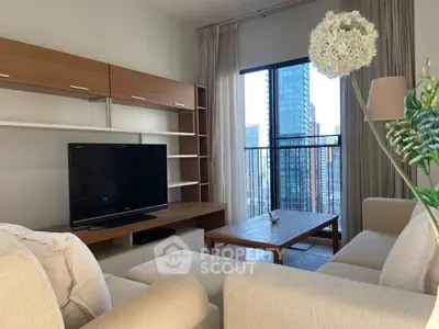 Modern living room with city view, featuring cozy beige sofas and sleek wooden furniture.