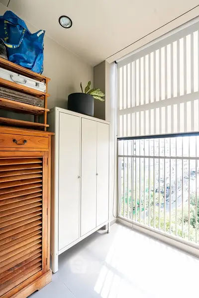Bright balcony with modern storage cabinets and city view