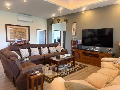 Spacious living room with modern decor, large sectional sofa, and flat-screen TV, perfect for family gatherings.