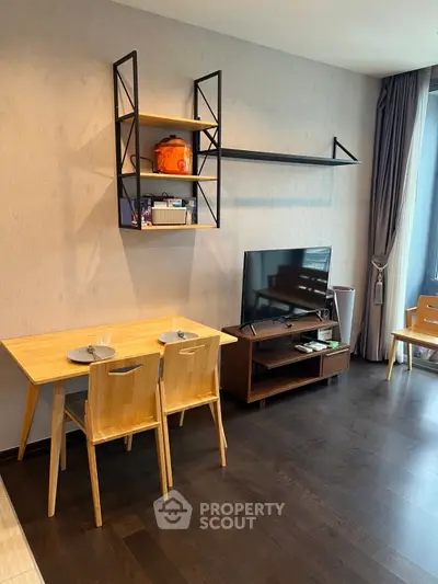 Modern living room with wooden furniture and TV setup, featuring stylish shelving and natural light.