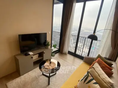 Modern living room with stunning city view from large windows and cozy decor.