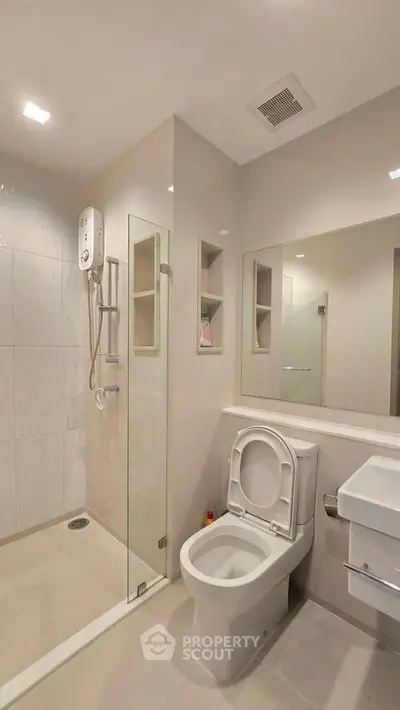 Modern bathroom with glass shower and sleek fixtures