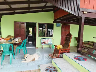 Charming rustic home with open-air living space and traditional wooden furniture, perfect for relaxation.
