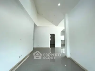 Spacious modern living room with high ceilings and sleek tile flooring