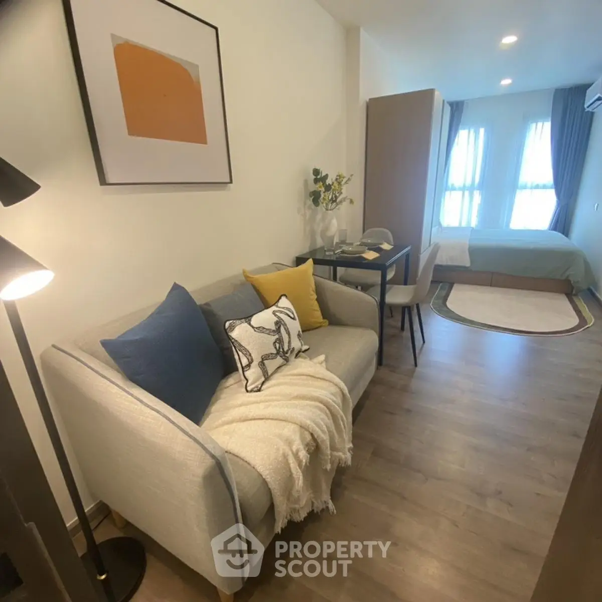 Modern studio apartment with cozy living area and stylish decor