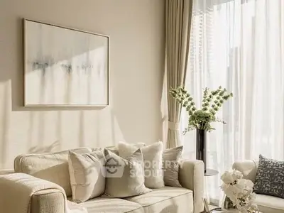Elegant living room with cozy beige sofa, stylish decor, and natural light through large windows.