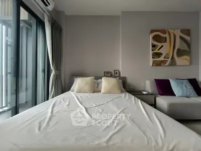 Modern bedroom with stylish decor and large windows offering natural light