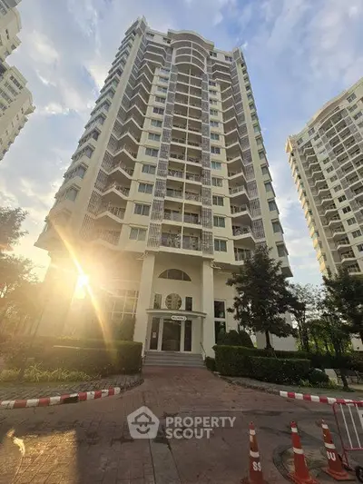 Stunning high-rise residential building with modern architecture and lush landscaping.