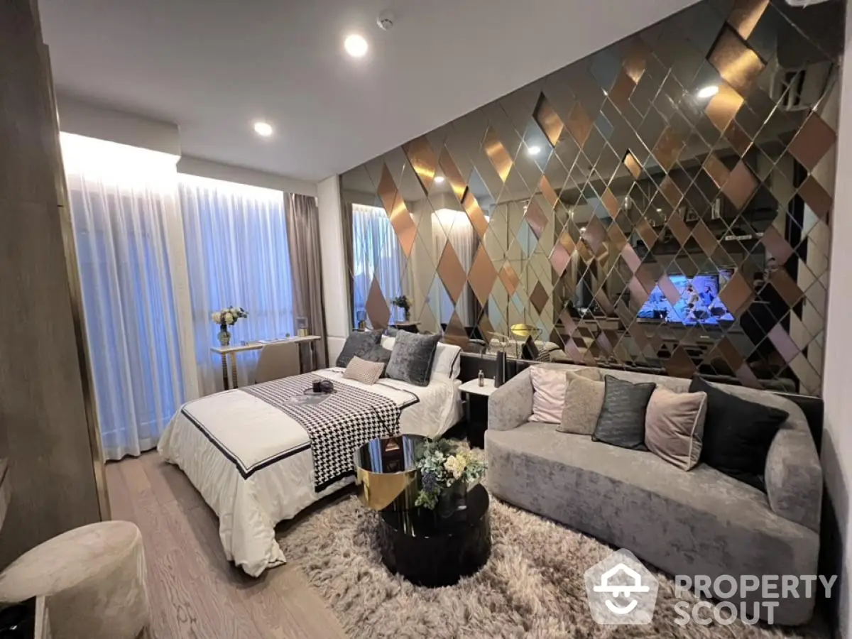 Luxurious bedroom with elegant decor and mirrored accent wall