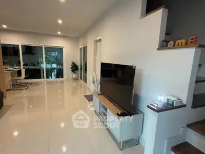 Spacious modern living room with sleek design and open layout, perfect for family gatherings.