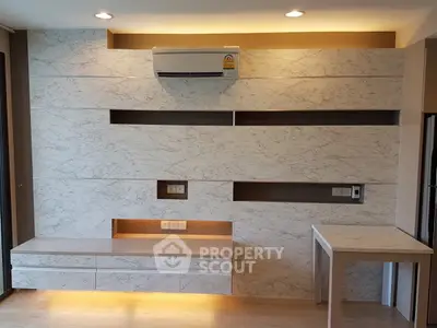 Modern living room with marble accent wall and built-in air conditioning unit.