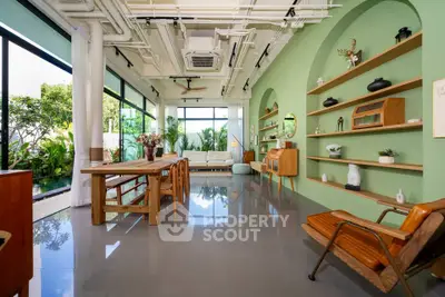 Stunning modern living room with green accents and large windows overlooking a lush garden.