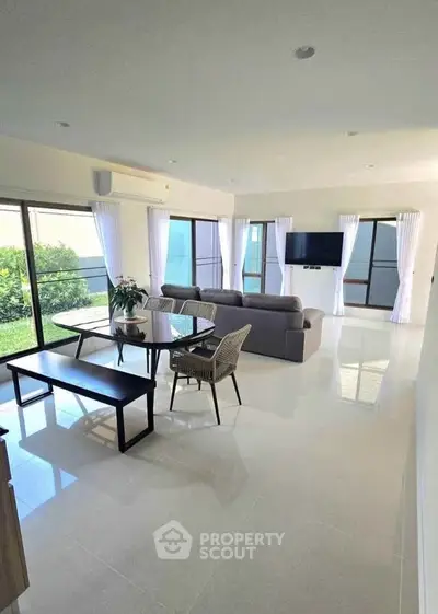 Spacious modern living room with garden view and elegant furnishings