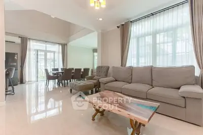 Spacious living room with elegant furniture and large windows in a modern home.