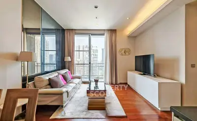 Luxurious living room with modern decor and stunning city view from large windows.