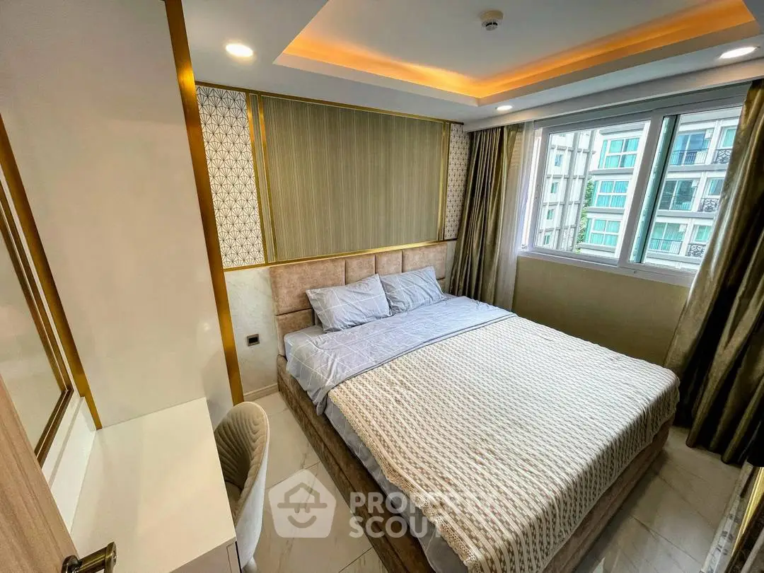 Luxurious bedroom with elegant decor and large window offering natural light in modern apartment.