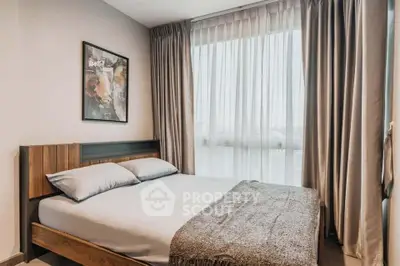 Cozy bedroom with modern decor and large window for natural light