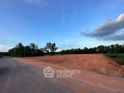 Expansive land plot with clear skies, ideal for development opportunities.