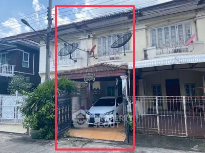Charming townhouse with carport and satellite dishes in a cozy neighborhood.