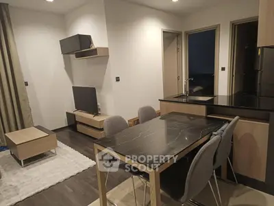 Modern open-plan living room and kitchen with sleek furniture and stylish decor