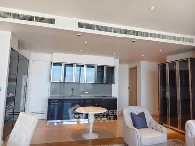 Spacious modern living room with sleek kitchen and elegant furnishings in luxury apartment.
