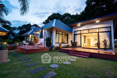 Stunning modern home with large windows and lush garden, perfect for serene living.