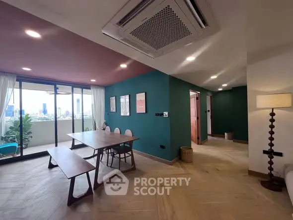 Spacious modern living room with balcony and city view