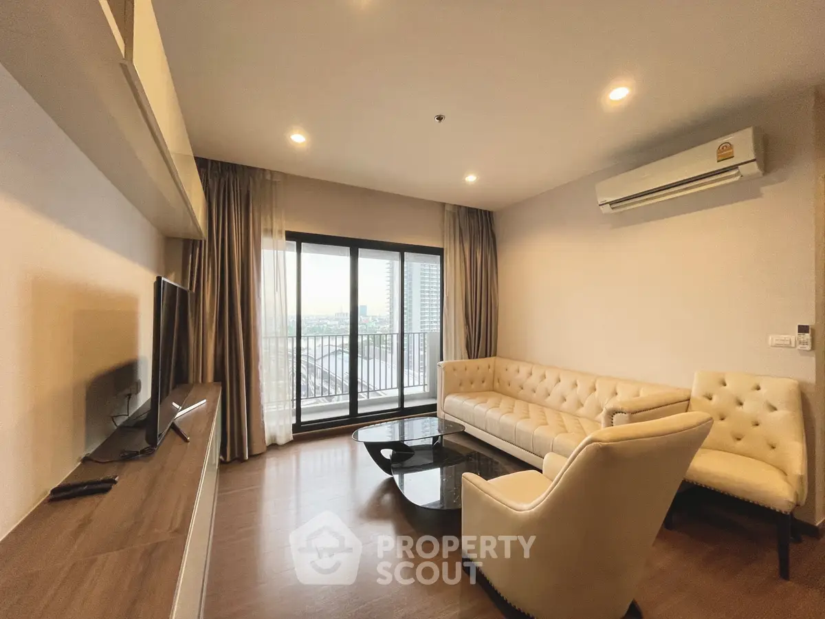 Spacious living room with elegant furniture and balcony view in modern apartment.