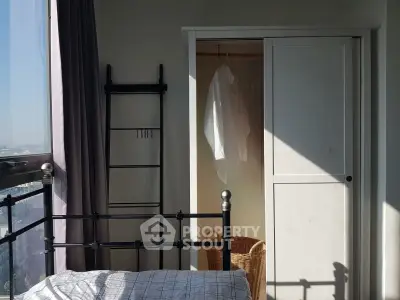Bright bedroom with closet and city view, featuring a cozy bed and modern decor.