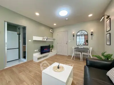 Modern living room with stylish decor and open layout, featuring a cozy dining area and sleek furniture.