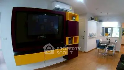 Modern living room with vibrant yellow and purple entertainment unit and sleek dining area.