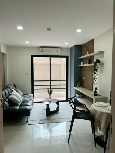 Modern living room with sleek furniture and balcony view
